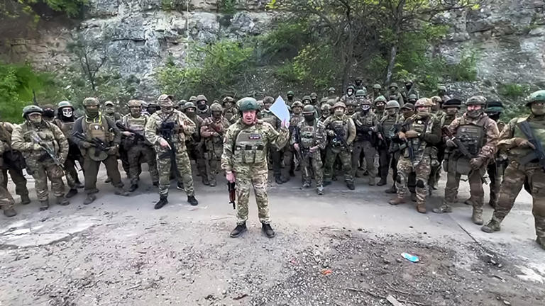 This video grab taken from a handout footage posted on May 5, 2023 on the Telegram account of the press-service of Concord -- a company linked to the chief of Russian mercenary group Wagner, Yevgeny Prigozhin -- shows Yevgeny Prigozhin addressing the Russian army's top brass standing in front of Wagner fighters at an undisclosed location. - The head of Russian paramilitary group Wagner on Friday threatened to pull his fighters from the front line in Bakhmut in eastern Ukraine on May 10, saying ammunition shortages meant they faced