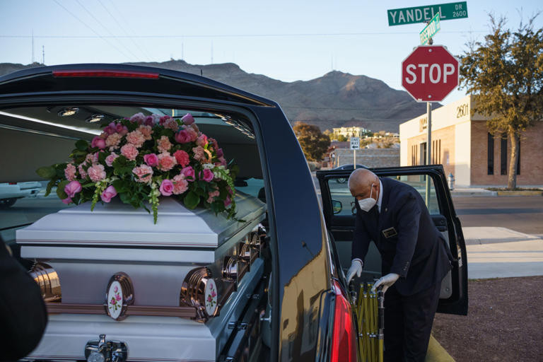 In the Getty image, Gabriel Tavarez prepares equipment inside of a hearse at Perches Funeral Home in El Paso, Texas, on December 4, 2020. - Funeral homes in El Paso have been dealing with an unprecedented number of Covid-19 related deaths in the last months. On Saturday, more than 100 community members gathered in Plain City, Ohio for the funeral of an unidentified newborn found in the back of a garbage truck earlier this month.